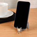 Tiltvo pocket phone stand holding a phone upright on a desk